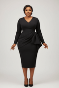 Woman wearing a black dress with a ruffled detail on a white background