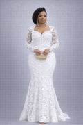 Woman wearing a white lace dress against a gray background