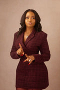 Woman wearing a burgundy dress against a beige background